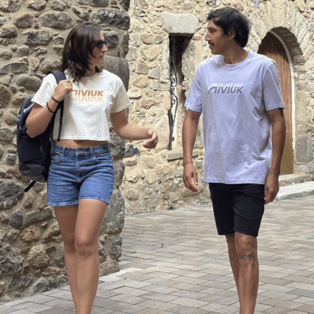 Niviuk Mirror Croptop, weißes T-Shirt mit goldenen Logo-Details, aus leichter, hochwertiger Baumwolle, ideal für stilvollen Komfort und Bewegungsfreiheit.