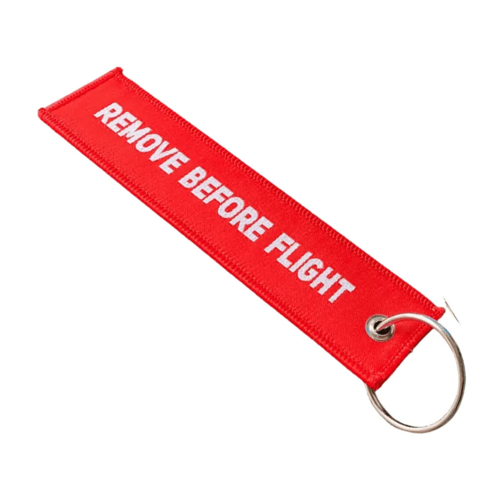 5-Punkte-Check Schlüsselanhänger mit Remove Before Flight-Text auf der Rückseite in rot mit weisser Schrift, hochwertig gewebt, ideal für Gleitschirmpiloten.