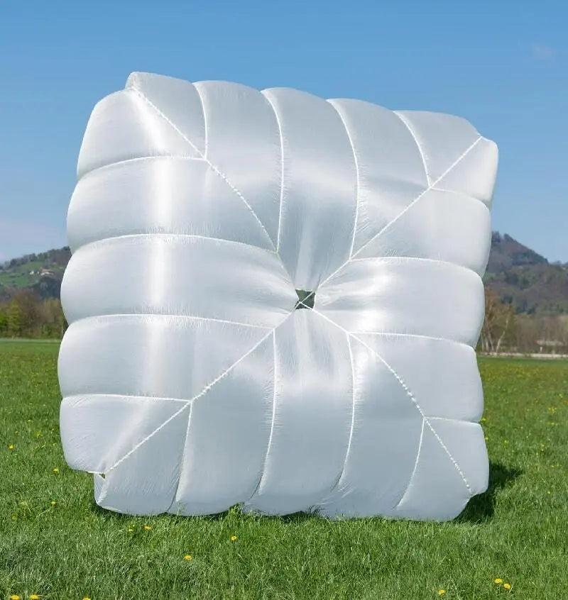 Icaro Square 115 Notschirm in einem Feld, zeigt quadratisches Design und leichte Materialien, ideal für Gleitschirmpiloten mit hoher Pendelstabilität und schneller Öffnung.