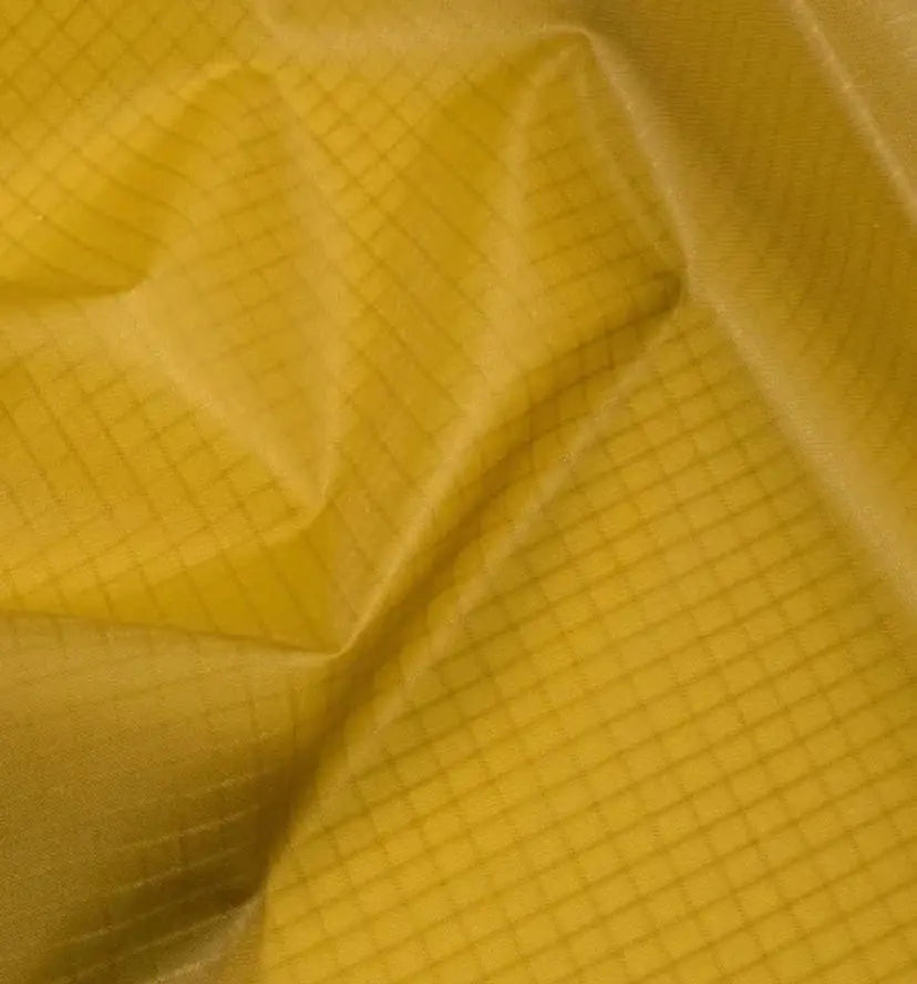 Ripstop Gleitschirmstoff selbstklebend (Meterware) mit Gittermuster, ideal für Gleitschirm-Reparaturen, 65g/m2, 96cm Breite, in Gelb dargestellt.